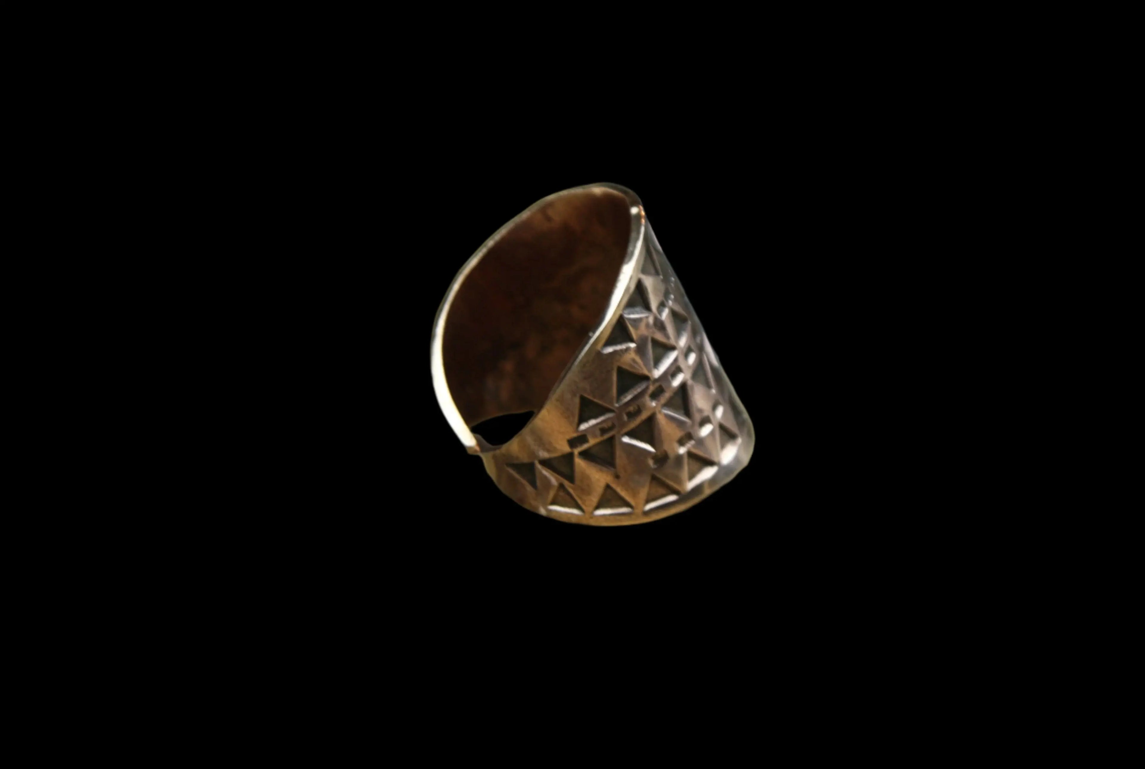 The side of a beautiful Bronze Hand Stamped Ring made in high copper alloy.