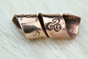 Bronze Hand Stamped Spiral Bead on fur